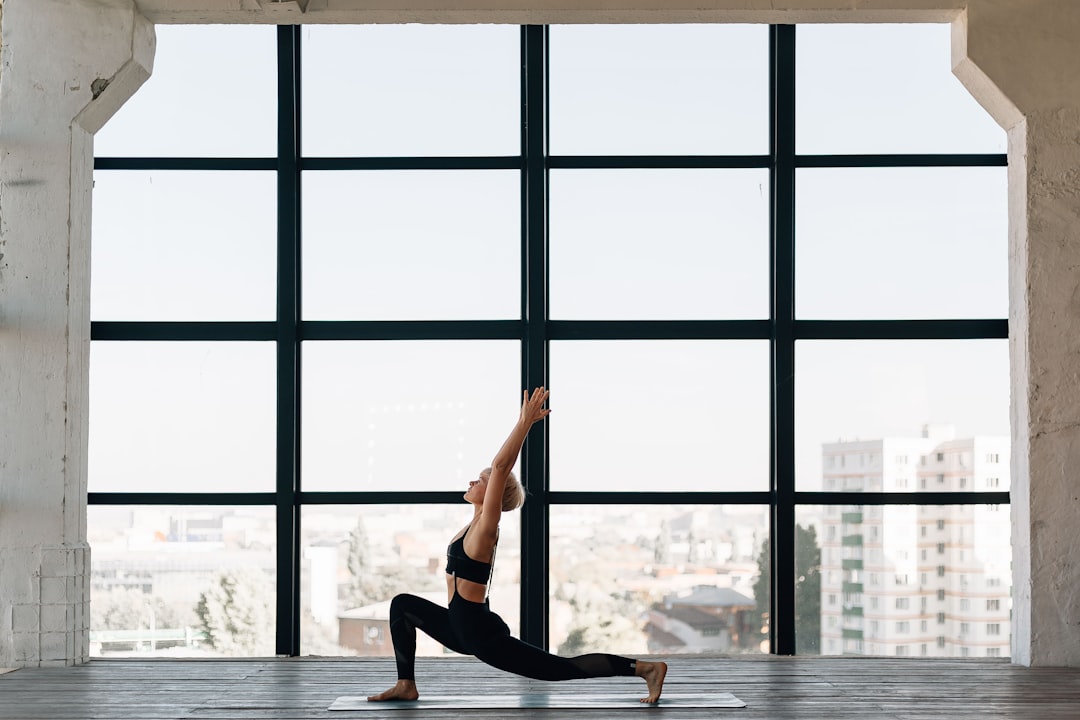 woman-in-black-tank-top-and-black-leggings-doing-yoga-siqmq-6726y